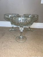 Three large crystal shrimp cocktail glasses shown upright, highlighting diamond-cut texture and stem design.