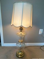 Full view of the vintage crystal table lamp with fabric shade illuminated, showing height and overall appearance.