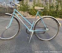 Full side view of a vintage light blue 1976 Favorit Rapido bicycle showing frame, wheels, and saddle.