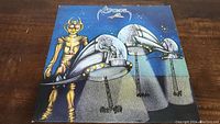 Front cover of the Araxis vinyl record album showing detailed sci-fi themed artwork with a golden robot and helmeted figures on a starry background.
