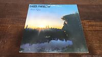 Front cover of the Barry Manilow Even Now vinyl album showing Barry Manilow's profile against a sunset city skyline.