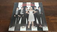 Front cover of Blondie Parallel Lines vinyl album showing the band members standing against a striped background with lead singer in white dress.