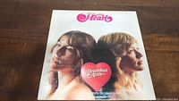 Front cover of Heart's Dreamboat Annie album featuring two women and a heart logo