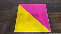 Square flag made from James Taylor vinyl album cover with half pink and half yellow geometric design