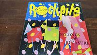 Front cover of vinyl record album Rockpile Seconds Of Pleasure, showing colorful abstract artwork and the album title.