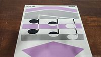 Front cover of Split Enz Waiata vinyl album showing abstract musical notes design in purple, black, white, and gray.