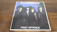 Front cover of The Inmates 'First Offence' vinyl LP album showing the band members in suits