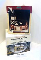 Box for Lemax Village Collection ceramic church building with wreath decoration on front and tall steeple, shown upright on white surface.