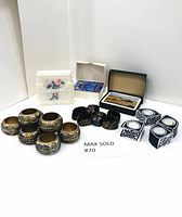 Overview photo showing all coasters, napkin rings, and napkin holder arranged together.