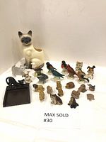 Overview of all figurines, cat vase, and note paper holder/tray on a white cloth background