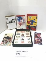 Full view of five Canadian 10-dollar stamp booklets and one black frame display with Canada 1982 stamps.