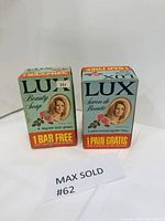 Two unopened vintage Lux Beauty Soap boxes side by side, showing full packaging and free bar offers