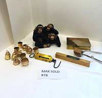 Overview of the lot showing three monkeys figurine, miniature copper pots, scale, level, hair clipper, and trinket box on a white background.
