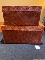 Stacked vintage seagrass boxes showing woven texture and overall shape.
