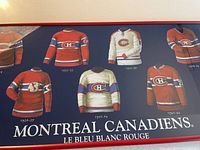 Close-up of six different vintage Montreal Canadiens jerseys painted on the artwork, showing the time span from 1910 to 1978-79.
