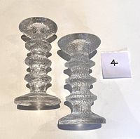 Pair of clear textured glass Iittala Festivo candle holders with three distinct rings visible along each holder. Marked with lot marker '4'.