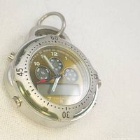 Photo showing the silver Coleman pocket watch face with analog hands, three small complication dials, and a digital display screen beneath center.