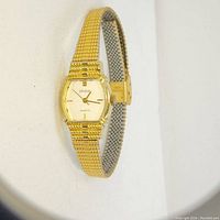 Front and side angled view of the Phasar vintage quartz wristwatch highlighting its gold-tone hexagonal case and matching gold-tone expandable band.