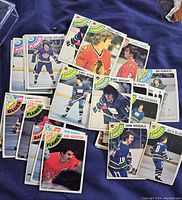 Various OPC hockey cards from the 1978-79 set spread on fabric showing multiple teams and players.