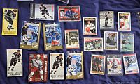 Photo showing an assortment of Wayne Gretzky hockey and promotional cards arranged on dark fabric.