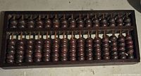Top view of the wooden abacus showing the arrangement of beads on rods within the frame.