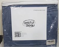 Packaged blue/grey bamboo sheet set in plastic with white label showing brand, restful sleep slogan, and QR codes with contact info.