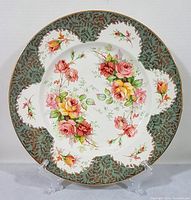 Full view of the hand painted Royal Staffordshire Clarice Cliff plate showing detailed floral design and decorative rim.