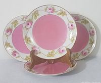 Set of 4 side plates displayed showing the front design featuring pink center and rose border.