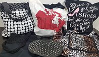 Six assorted handbags and tote bags displayed together showing variety of patterns and sizes.
