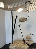 Both large and small bird sculptures displayed together on white backdrop.