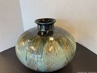 Photo showing the rounded large ceramic pot with glossy glaze and earthy colors