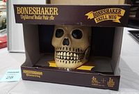 Bone shaker skull mug in original box, showing front view of the skull design inside boxed packaging.