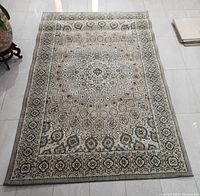 Full view of the grey patterned Karastan Touchstone rug laid flat on tiled floor showing overall design and condition.