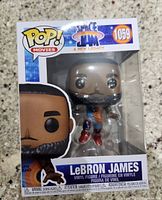 Front view of Funko Pop! LeBRON JAMES Space Jam #1059 in original packaging showing figure inside with Space Jam and Pop! Movies branding.