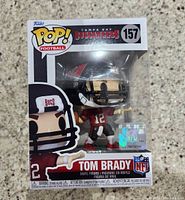 Photo of Funko Pop! Tom Brady Tampa Bay Buccaneers vinyl figure in original sealed box showing figure and packaging details