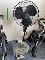 Two fans side by side; one Honeywell adjustable stand fan and one vintage Sears tabletop fan.