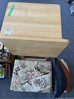 Overhead view of wood folding TV tables and floral upholstered storage stool.