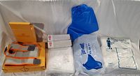 Photo showing full lot with knee wraps, gloves, shoe protectors, aprons, and sterile suit.