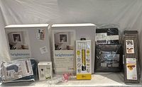 Overview of all new home items in original packaging including shelves, chair covers, curtain sets, cat scratcher box, and miscellaneous items