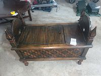 Angled view of entire antique wooden bench showing top and side details