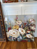 Photo showing 27x27 inch square canvas with colorful impressionistic floral painting, featuring white and yellow flowers.