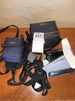 Two camera cases, one Nikon branded and one blue, with lot tag.