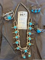 All four pieces on black background with lot tag