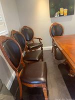 Overview of four chairs around table showing one armchair and three side chairs
