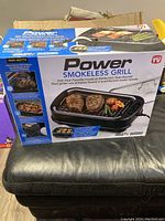 Front view of the Power Smokeless Grill box showing product image and features.