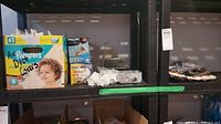 Photo showing boxes including 'Air Pampers' branded air duct covers, Philips lightbulbs, and assorted hardware items on a shelf