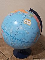Full view of the George F. Cram Imperial World Globe showing North Pacific Ocean and surrounding continents with label.