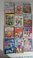 Photo showing 12 children's DVDs including titles from PBS Kids like Daniel Tiger, PJ Masks, Elmo, Barbie and The Lorax