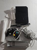 Top-down view of the Wii console with controllers, sensor bar, and power adapter