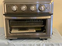 Front view of Cuisinart Airfryer Toaster Oven showing control knobs and closed door.